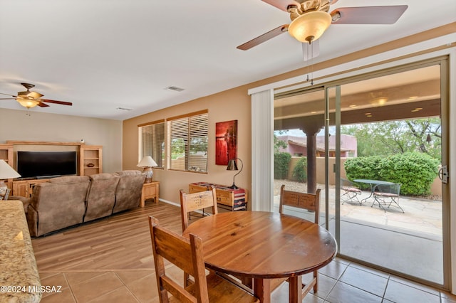 dining room featuring a ceiling fan, visible vents, and light tile patterned floors