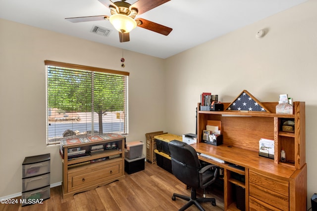 office space featuring wood finished floors, visible vents, and a ceiling fan