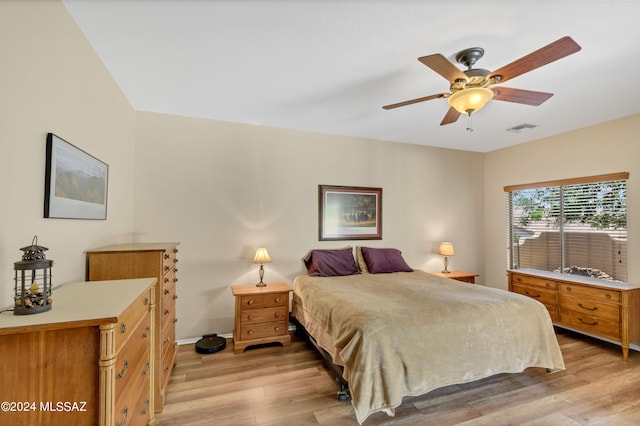 bedroom featuring light wood finished floors, baseboards, a ceiling fan, and visible vents