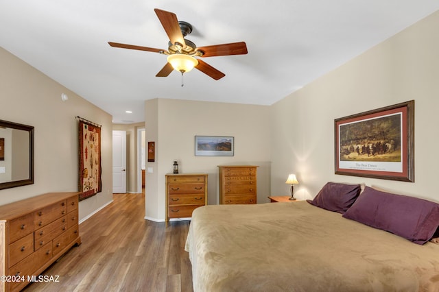 bedroom with baseboards, wood finished floors, and ceiling fan