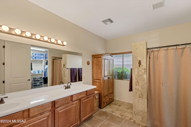 bathroom featuring tile patterned floors, a sink, and visible vents