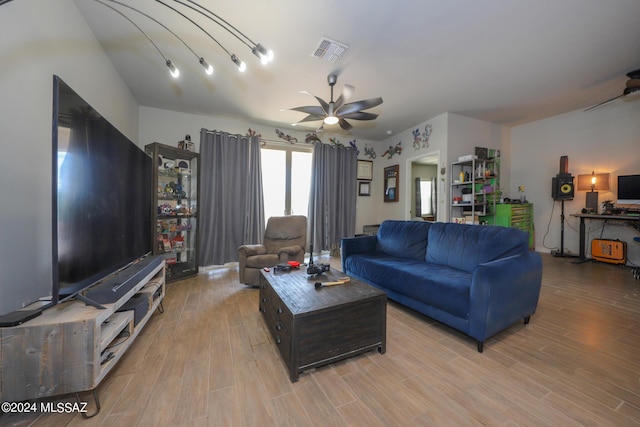 living room with ceiling fan and light hardwood / wood-style flooring