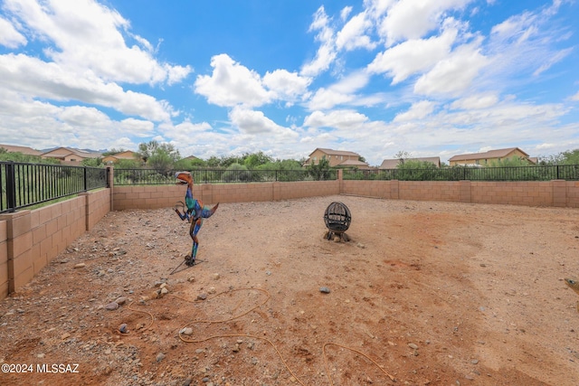 view of yard with an outdoor fire pit