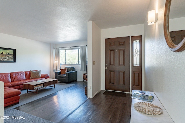 entrance foyer with a textured ceiling and dark wood-type flooring