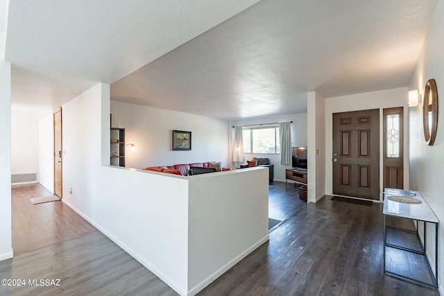 living room featuring dark hardwood / wood-style floors and a textured ceiling