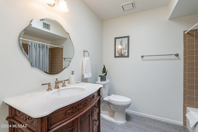 bathroom with toilet, hardwood / wood-style floors, a shower with curtain, and vanity