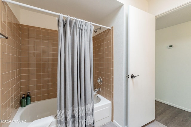 bathroom featuring hardwood / wood-style floors and shower / bath combination with curtain