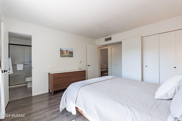 bedroom with dark hardwood / wood-style floors and ensuite bathroom