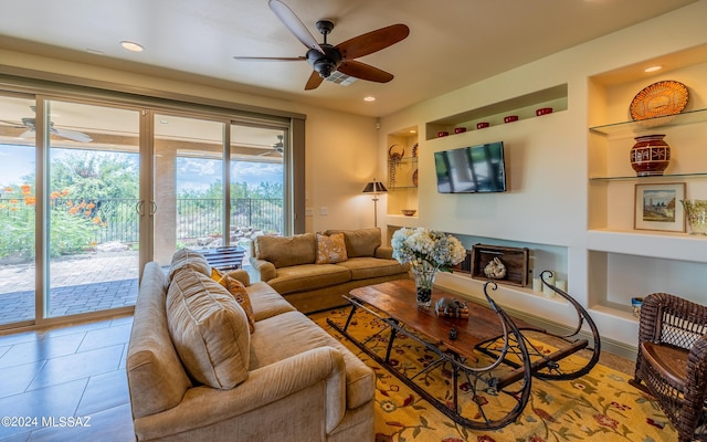 living area with a ceiling fan, tile patterned floors, built in shelves, and recessed lighting