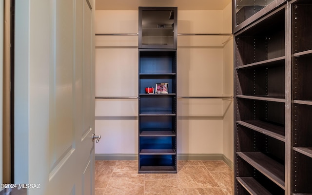 walk in closet featuring light tile patterned floors