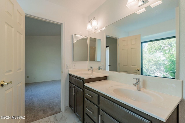 bathroom with tile patterned floors and dual vanity