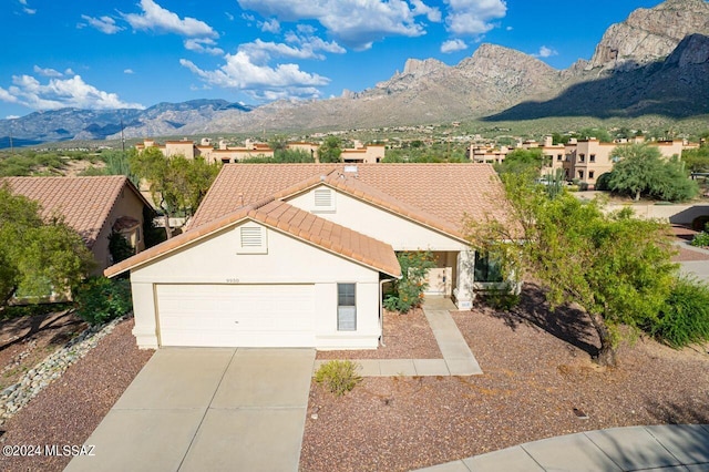 view of front of property with a mountain view and a garage