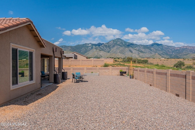 view of yard featuring a mountain view and a patio area