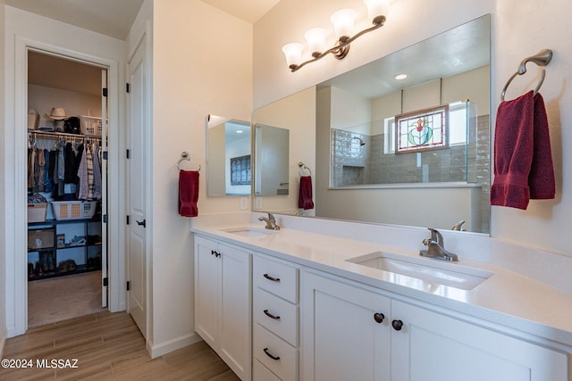 bathroom featuring walk in shower, vanity, and hardwood / wood-style floors