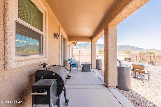 view of patio / terrace featuring a mountain view and a grill