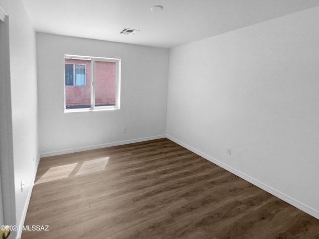 unfurnished room with wood-type flooring