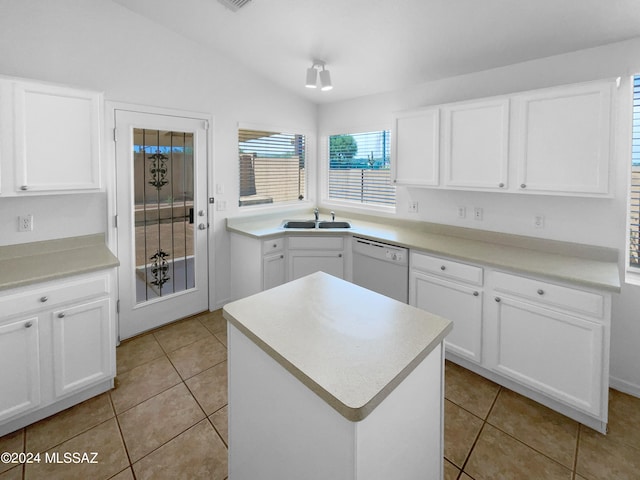 kitchen featuring white cabinets, white dishwasher, light tile patterned floors, and lofted ceiling