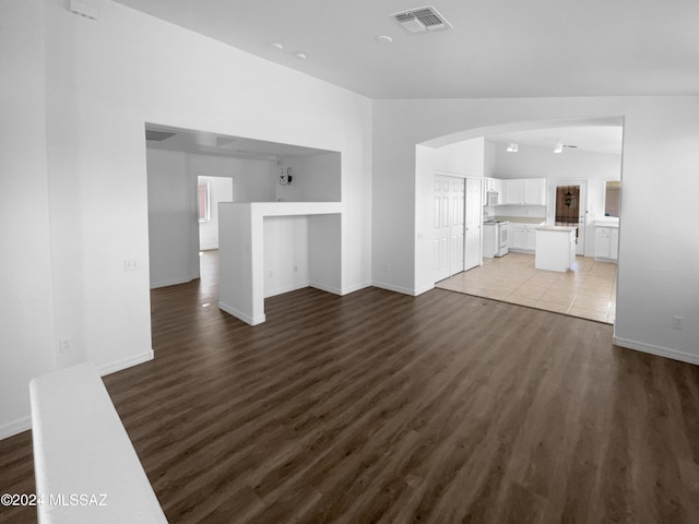 unfurnished living room featuring dark hardwood / wood-style flooring