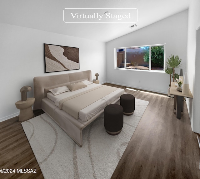 bedroom featuring lofted ceiling and dark wood-type flooring