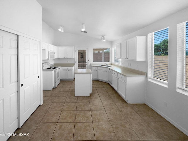 kitchen featuring sink, white cabinetry, a kitchen island, white appliances, and tile patterned flooring