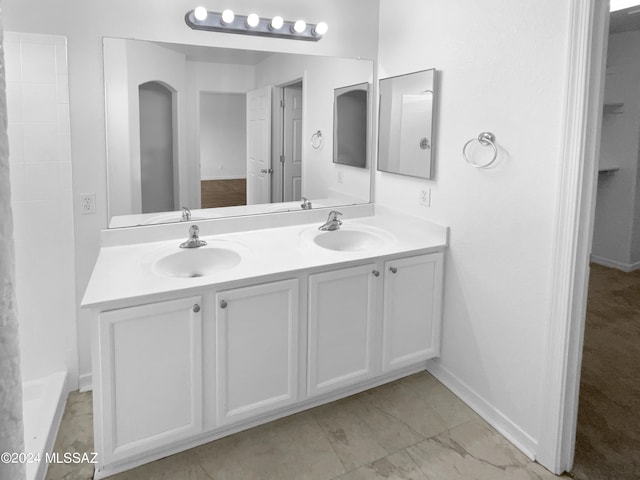 bathroom featuring tile patterned floors and double sink vanity