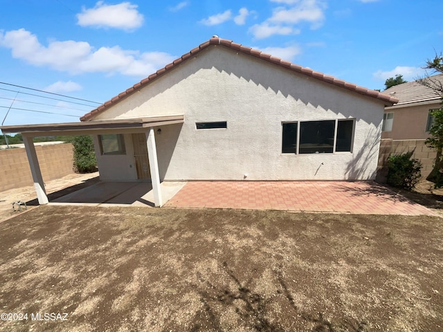 back of property with a patio area