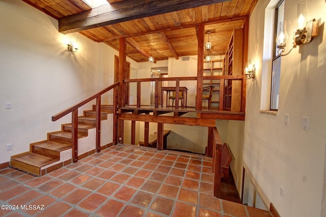 interior space featuring tile patterned floors and wooden ceiling