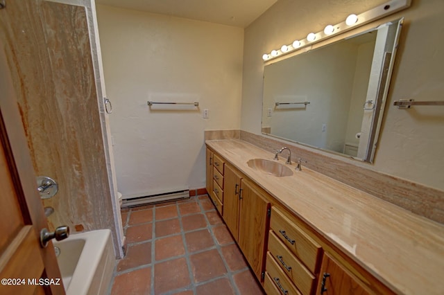 full bathroom featuring vanity, tile patterned floors, toilet, baseboard heating, and separate shower and tub