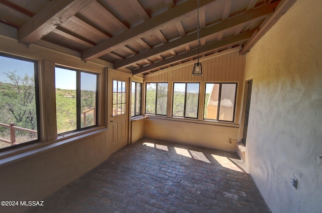 unfurnished sunroom with lofted ceiling