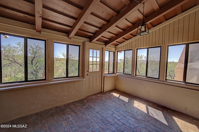 unfurnished sunroom with wooden ceiling and vaulted ceiling with beams