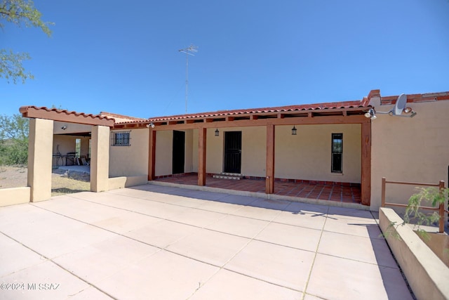 back of property with a patio