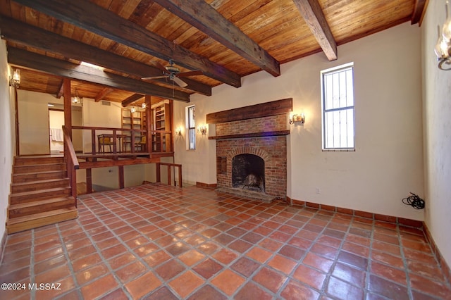 unfurnished living room featuring wood ceiling, stairway, tile patterned flooring, a fireplace, and beam ceiling