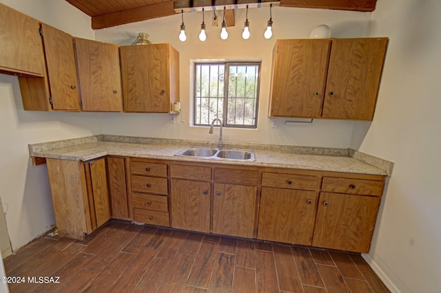 kitchen with sink, dark wood-type flooring, wooden ceiling, and lofted ceiling with beams