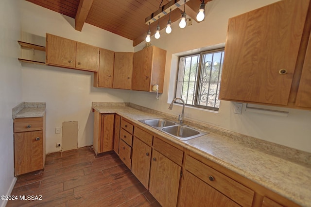 kitchen with sink, vaulted ceiling with beams, wooden ceiling, and track lighting