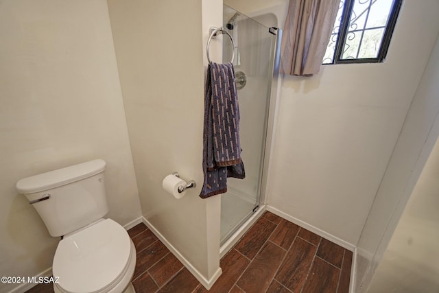 bathroom featuring an enclosed shower and toilet