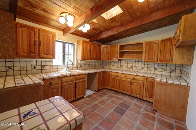 kitchen with wooden ceiling, decorative backsplash, and tile countertops