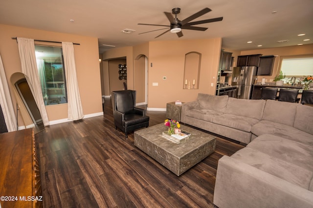 living room featuring ceiling fan, dark hardwood / wood-style flooring, and sink