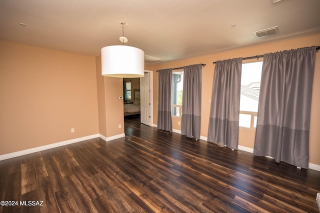 spare room featuring dark wood-type flooring