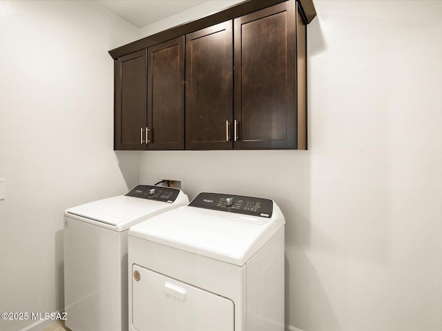 laundry room featuring washing machine and dryer and cabinet space