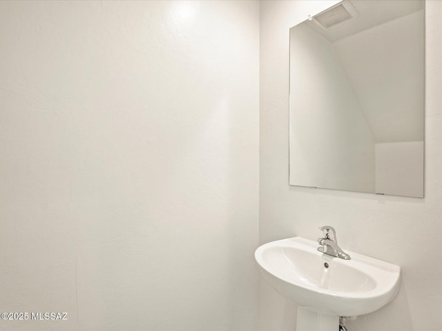 bathroom with visible vents and a sink