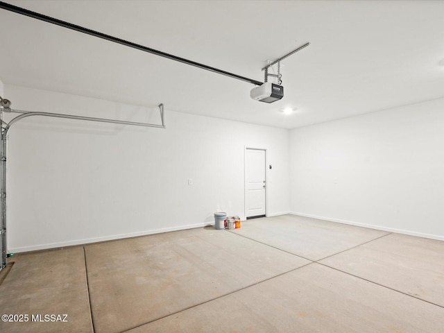 garage with baseboards and a garage door opener