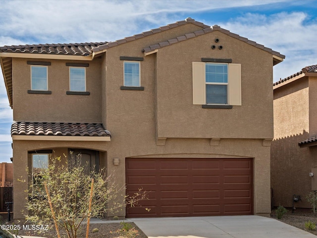 view of front of home featuring a tile roof, concrete driveway, a garage, and stucco siding