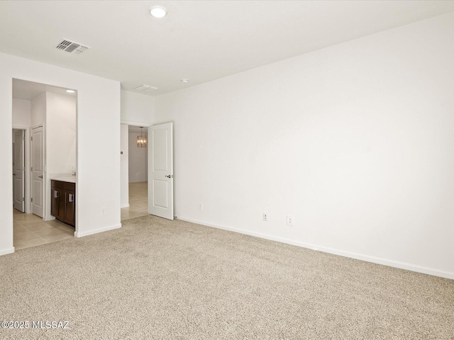 unfurnished bedroom with baseboards, light carpet, recessed lighting, and visible vents