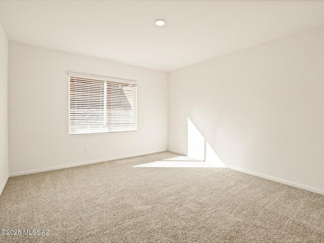 carpeted spare room featuring recessed lighting and baseboards