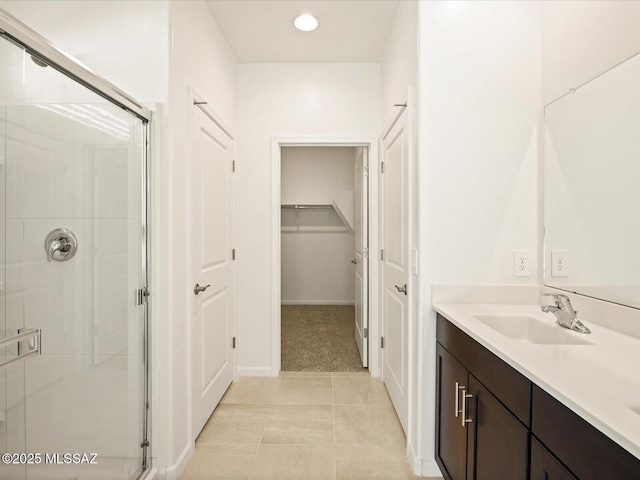 full bathroom with vanity, tile patterned floors, a stall shower, and recessed lighting