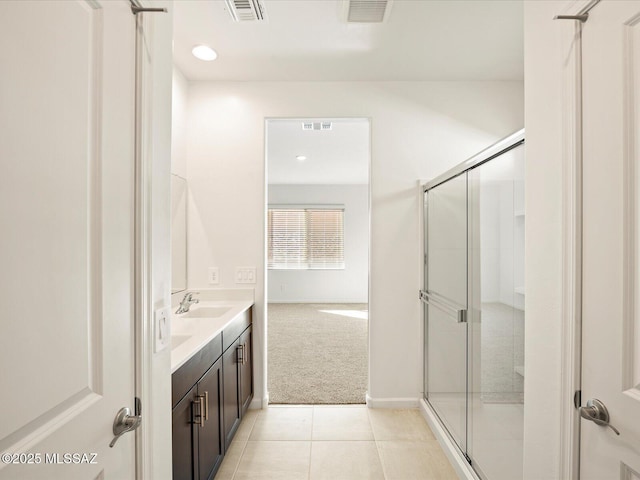 bathroom featuring visible vents, a shower stall, and tile patterned flooring