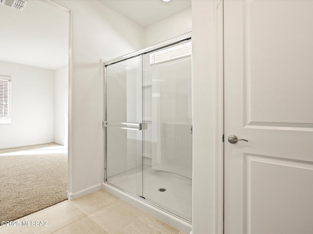 bathroom featuring visible vents, a shower stall, and a healthy amount of sunlight