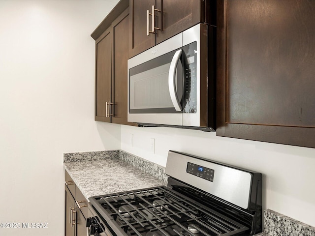 kitchen with stainless steel appliances and dark brown cabinets