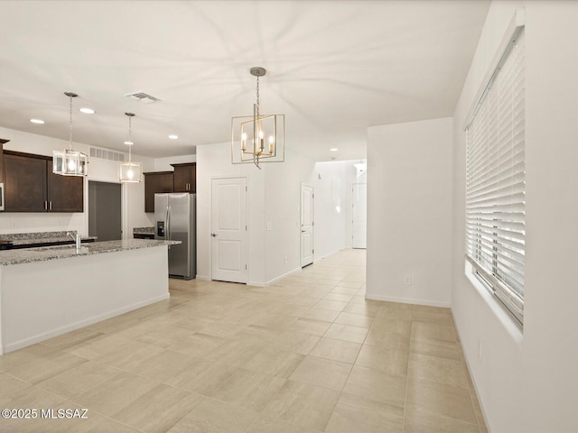 kitchen featuring dark brown cabinetry, stainless steel refrigerator with ice dispenser, a chandelier, and visible vents