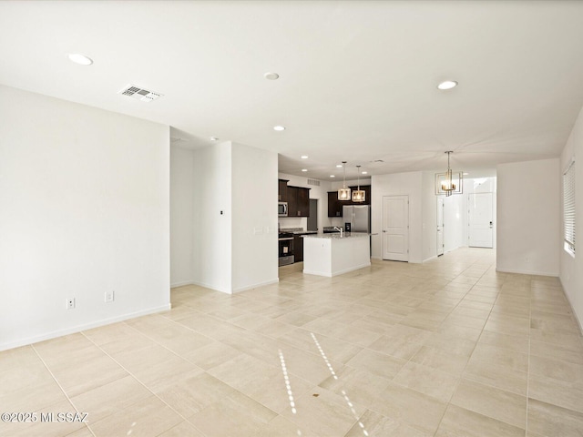 unfurnished living room featuring visible vents, recessed lighting, light tile patterned floors, and a notable chandelier